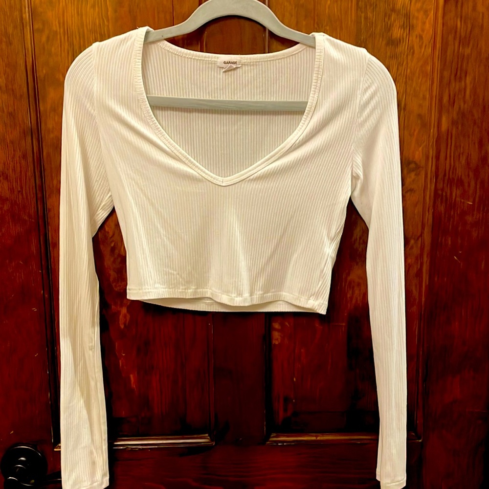 Adorable white, soft long sleeved crop top with low neck line from Garage!
